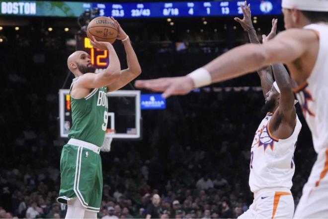 Derrick White launches a triple in the game against the Celtics.