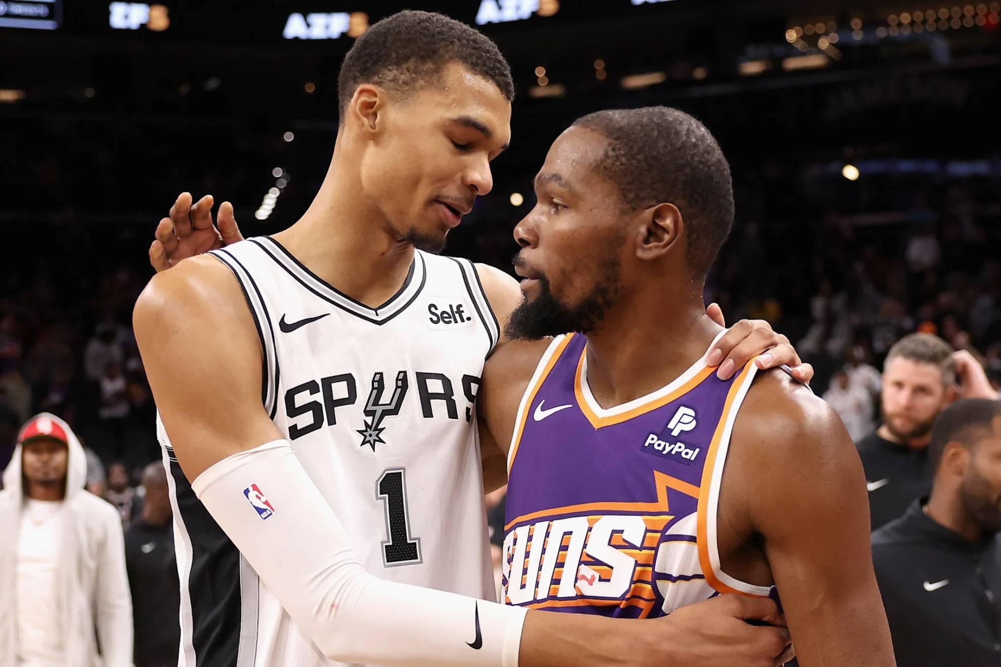 Kevin Durant and Victor Wembanyama embrace after an encounter