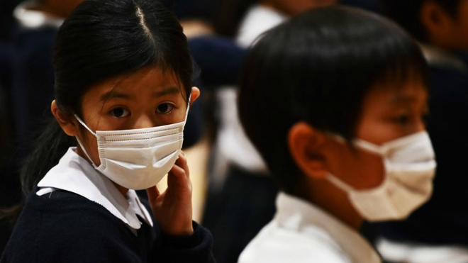 Niños con mascarillas en un colegio de Tokio.