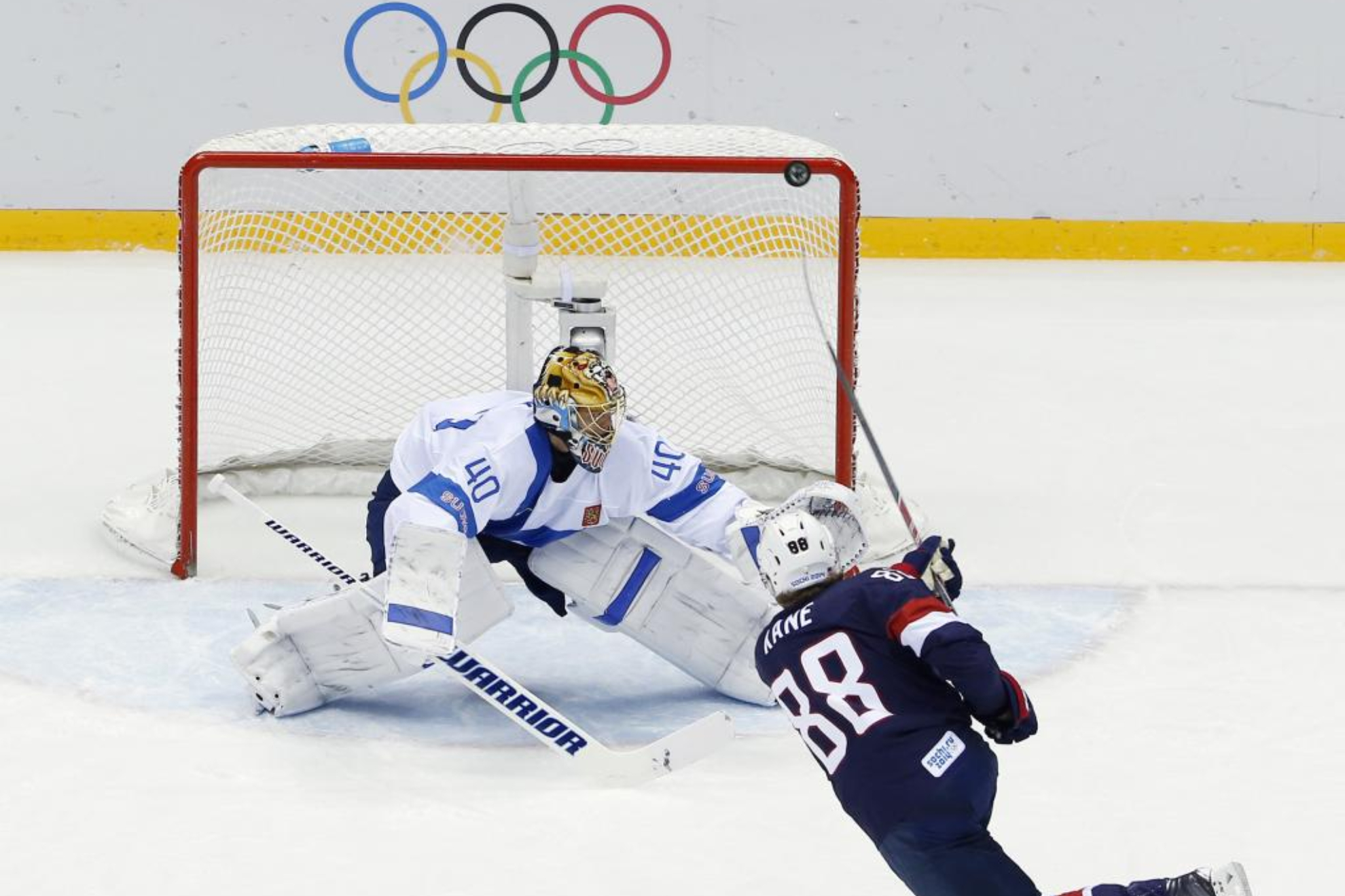 Patrick Kane de Estados Unidos lanza a la portería de Finlandia en el partido por el bronce de los Juegos de 2014