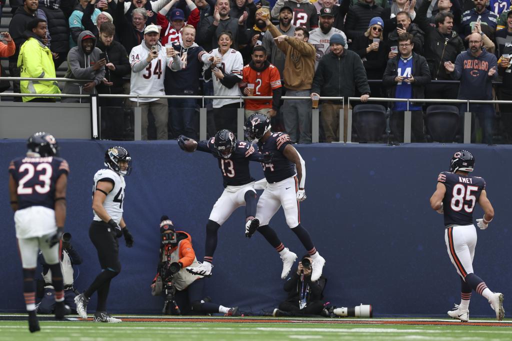 The Bears celebrate their touchdown while the crowd cheers.