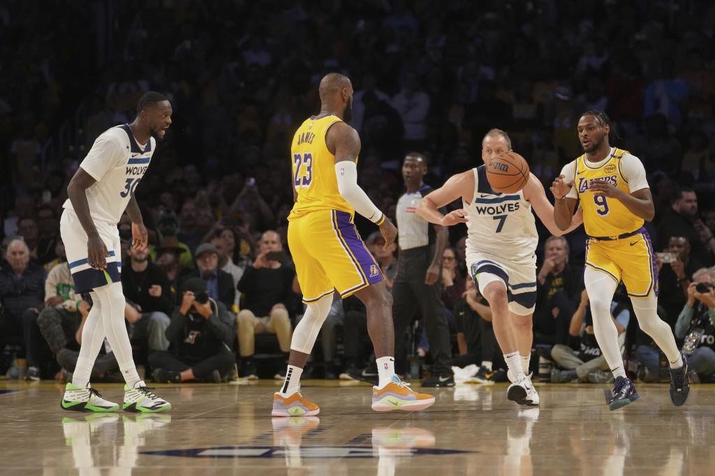 Los Angeles Lakers forward LeBron James (23) passes to guard Bronny James (9) during the first half of an NBA basketball game against the Minnesota Timberwolves, Tuesday, Oct. 22, 2024, in Los Angeles. (AP Photo/Eric Thayer)