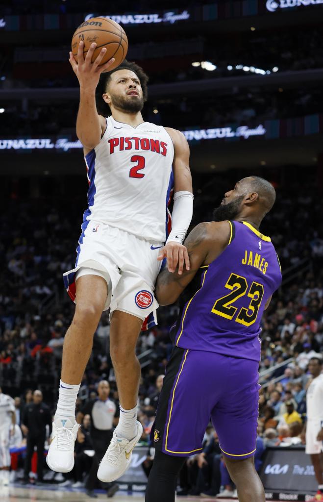 Detroit Pistons guard Cade Cunningham (2) takes a shot past Los Angeles Lakers forward LeBron James (23) during the second half of an NBA basketball game Monday, Nov. 4, 2024, in Detroit. (AP Photo/Duane Burleson)