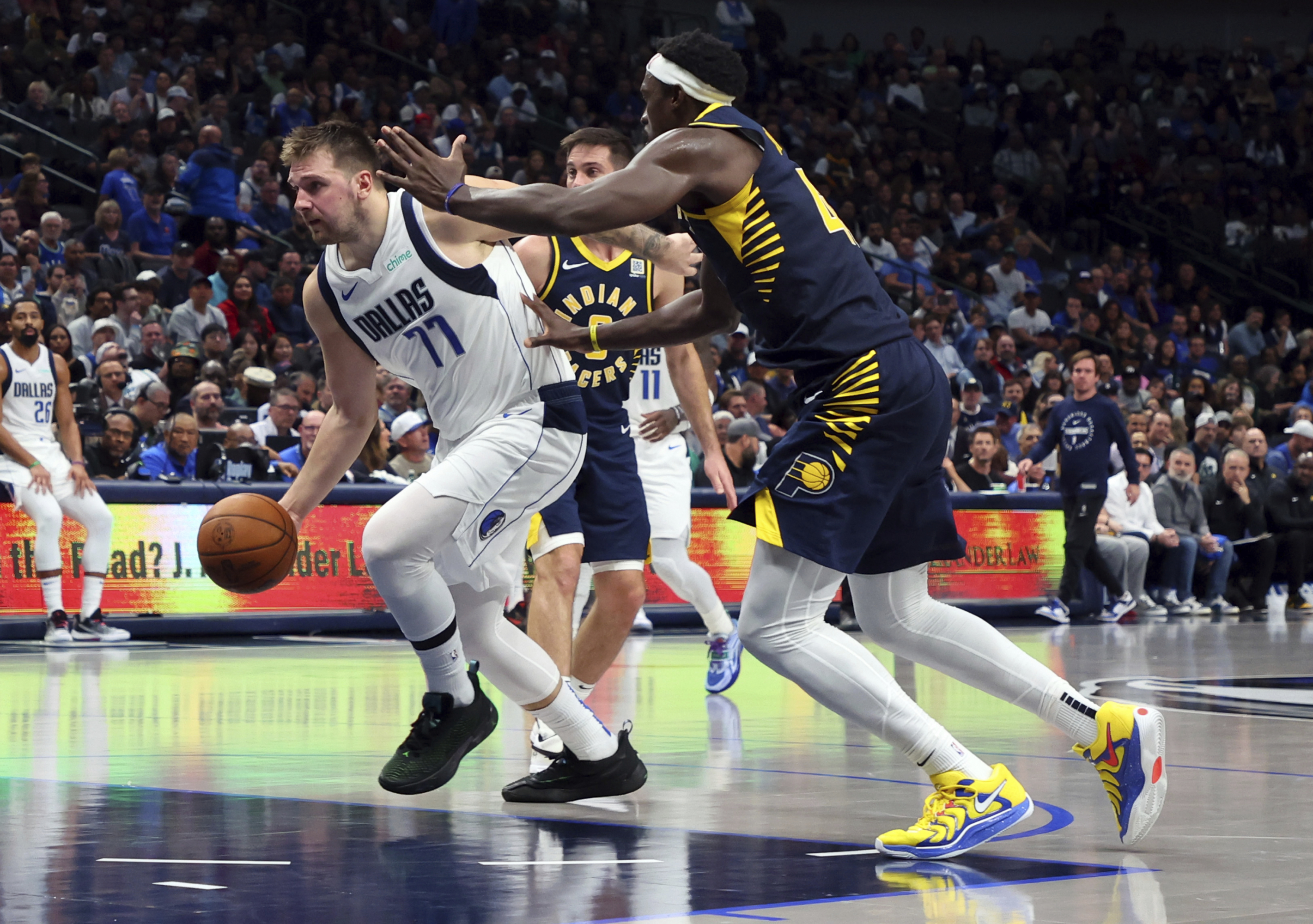 Dallas Mavericks guard Luka Doncic (77) drives to the basket past Indiana Pacers forward Pascal Siakam (43) in the second half of an NBA basketball game Saturday, Nov. 4, 2024, in Dallas. (AP Photo/Richard W. Rodriguez)