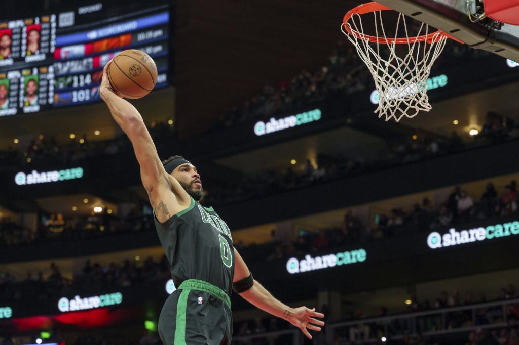 Boston Celtics forward Jayson Tatum (0) goes up for a slam dunk during the second half of an NBA basketball game against the Atlanta Hawks, Monday, Nov. 4, 2024, in Atlanta. (AP Photo/Jason Allen)