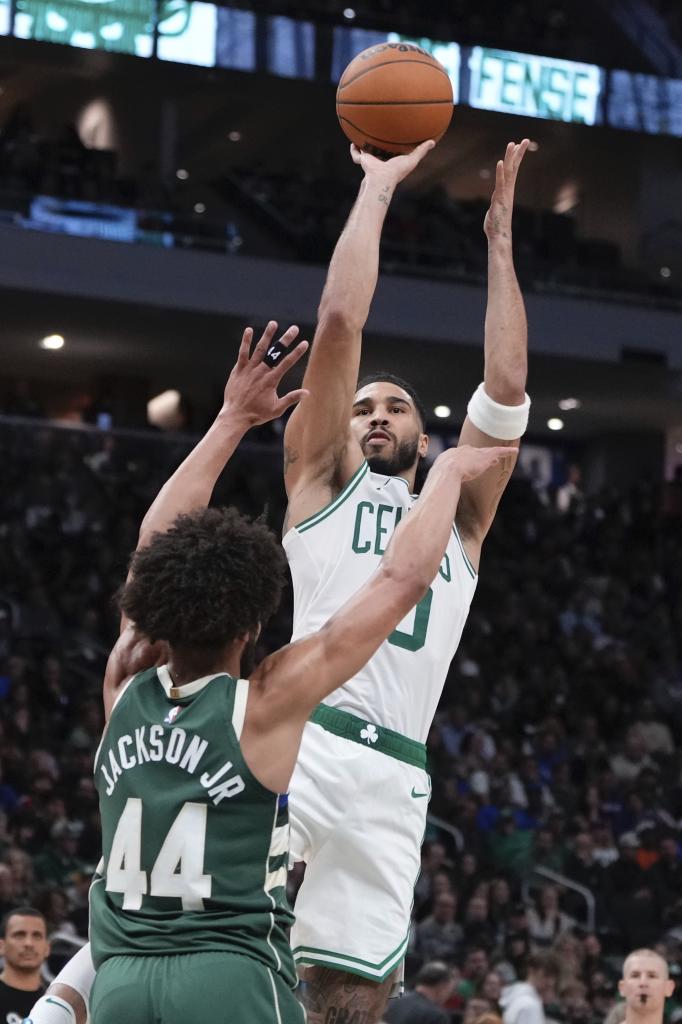 Jayson Tatum throws over Jaden Springer.
