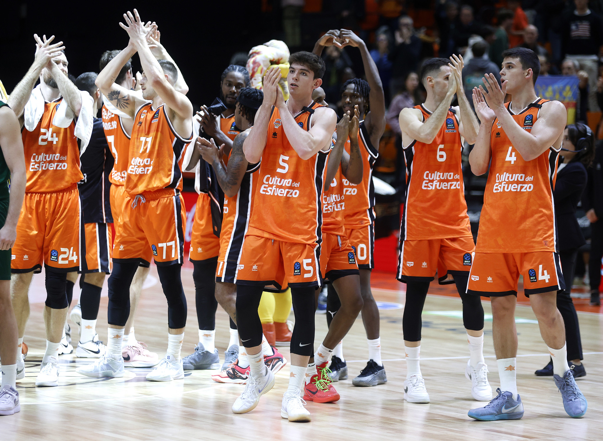 Valencia players applaud the fans after the game.