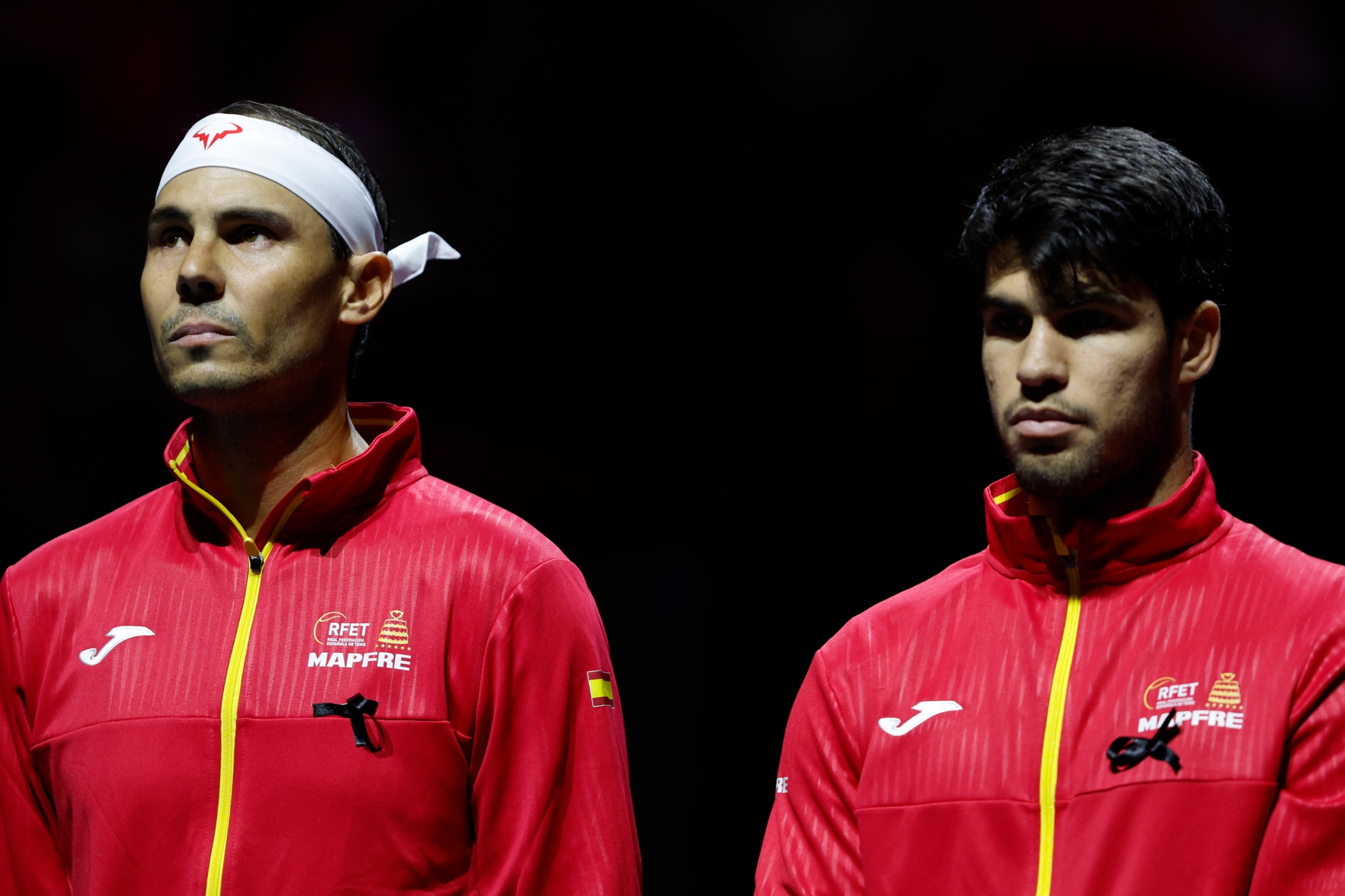 Nadal and Alcaraz listen to the Spanish anthem before the Davis Cup tie.
