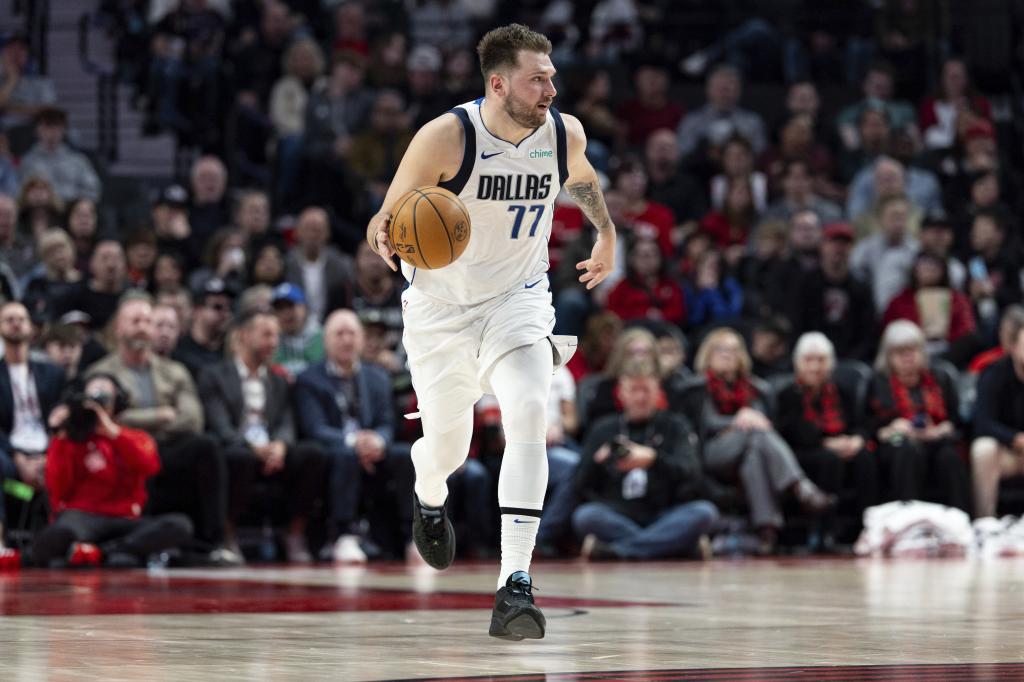 Dallas Mavericks guard Luka Doncic dribbles the ball up the court against the Portland Trail Blazers during the first half of an NBA basketball game Sunday, Dec. 1, 2024, in Portland, Ore. (AP Photo/Howard Lao)