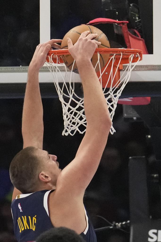 Denver Nuggets center Nikola Jokic dunks in the first half of an NBA basketball game against the Cleveland Cavaliers, Thursday, Dec. 5, 2024, in Cleveland. (AP Photo/Sue Ogrocki)