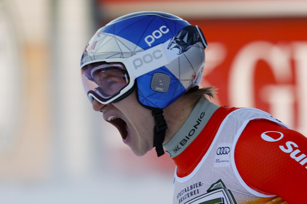 Switzerland's Marco Odermatt celebrates at the finish area of an alpine ski, men's World Cup downhill, in Val Gardena, Italy, Saturday, Dec. 21, 2024. (AP Photo/Alessandro Trovati)