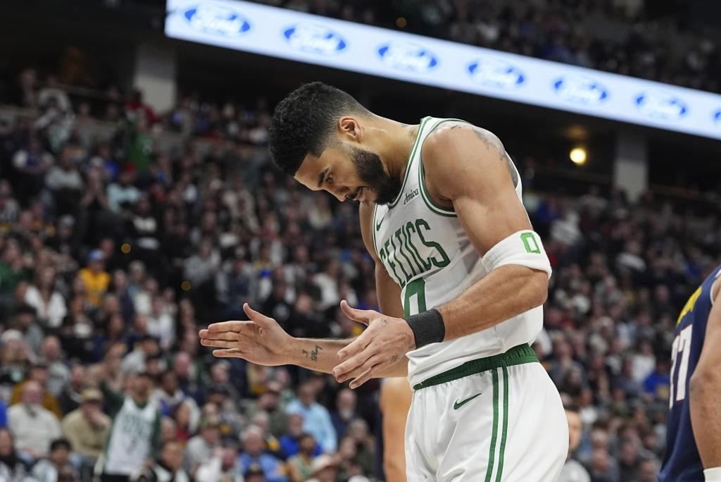 Boston Celtics forward Jayson Tatum reacts after dunking the ball for a basket and drawing a foul in the first half of an NBA basketball game against the Denver Nuggets, Tuesday, Jan. 7, 2025, in Denver. (AP Photo/David Zalubowski)