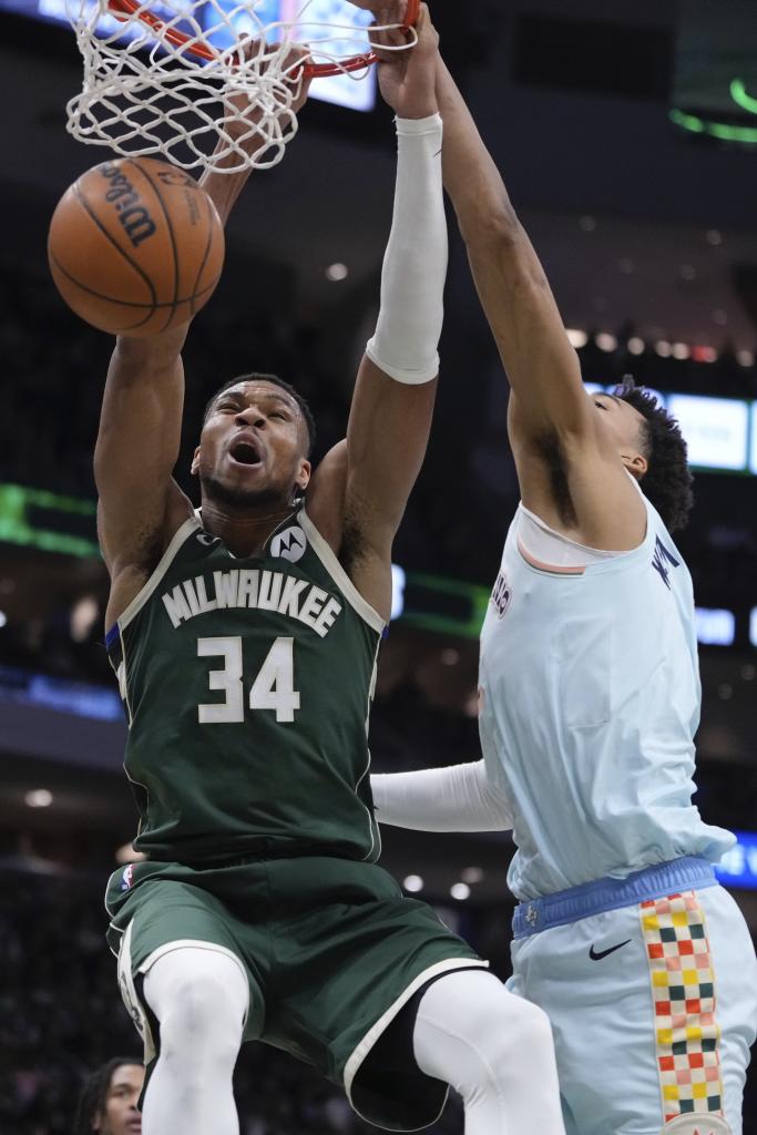 Milwaukee Bucks' Giannis Antetokounmpo dunks past San Antonio Spurs' Victor Wembanyama during the first half of an NBA basketball game Wednesday, Jan. 8, 2025, in Milwaukee. (AP Photo/Morry Gash)