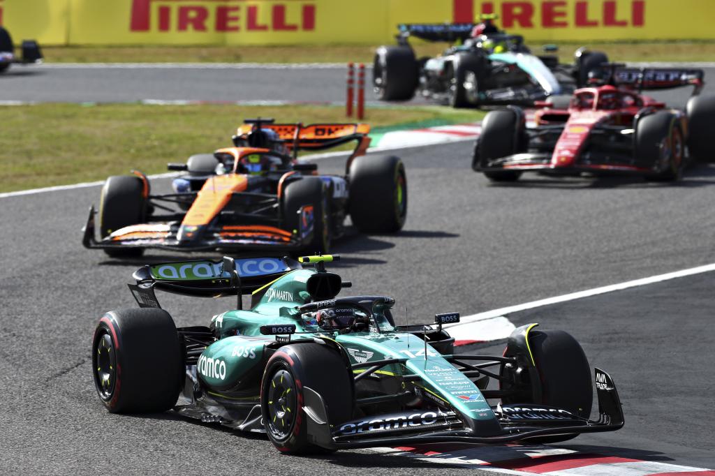 SUZUKA, JAPAN - APRIL 07: Fernando Alonso of Spain driving the (14) Aston Martin AMR24 Mercedes leads Oscar Piastri of Australia driving the (81) McLaren MCL38 Mercedes during the F1 Grand Prix of Japan at Suzuka International Racing Course on April 07, 2024 in Suzuka, Japan. (Photo by Peter Fox/Getty Images)