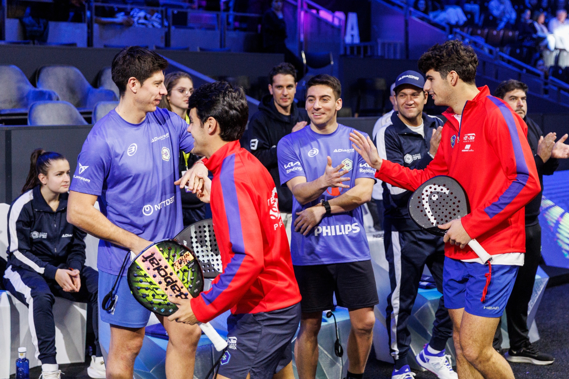 Coki and Coello greet Di Nenno and Tello before a game.