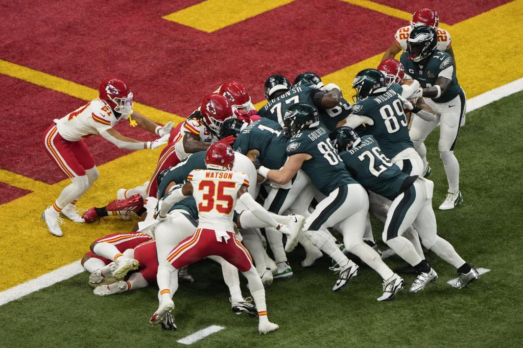 Philadelphia Eagles quarterback Jalen Hurts (1) scores against the Kansas City Chiefs during the first half of the NFL Super Bowl 59 football game, Sunday, Feb. 9, 2025, in New Orleans. (AP Photo/Charlie Riedel)