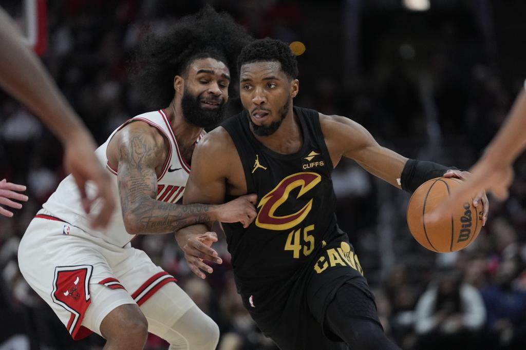 Donovan Mitchell intenta superar la defensa de Coby White.