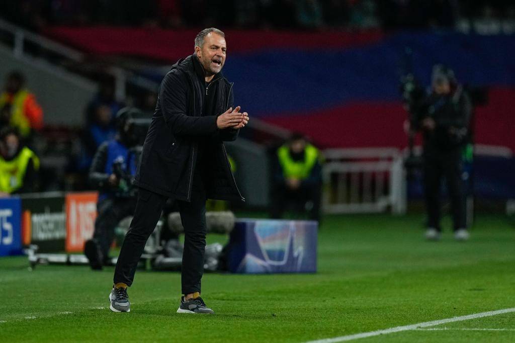 Flick applauds his players during a game.