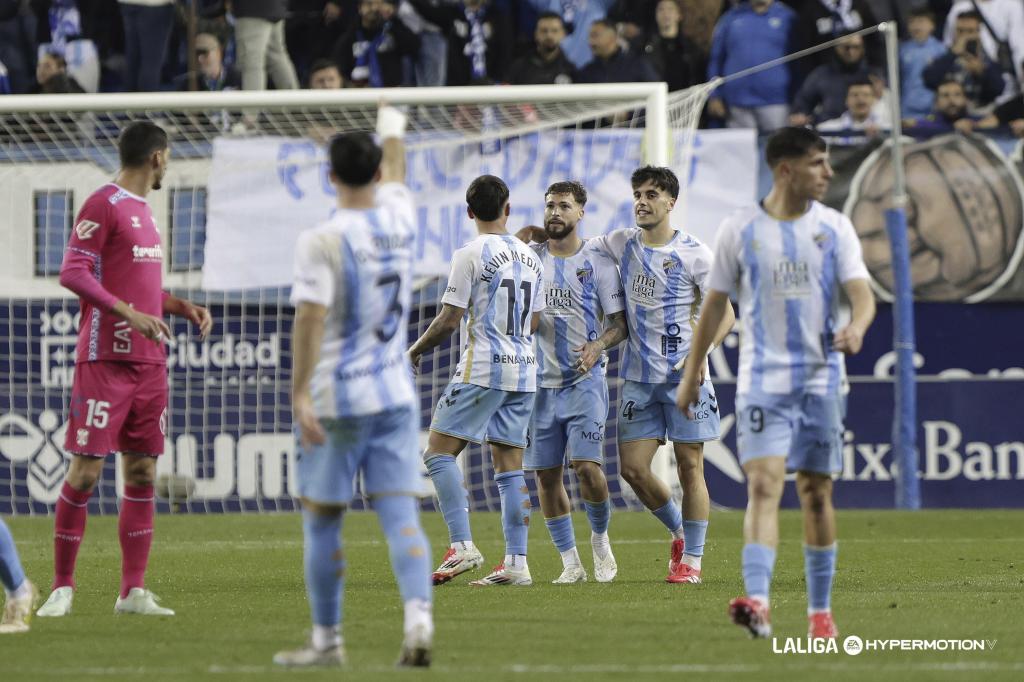 Malaga players celebrate a goal against Tenerife.