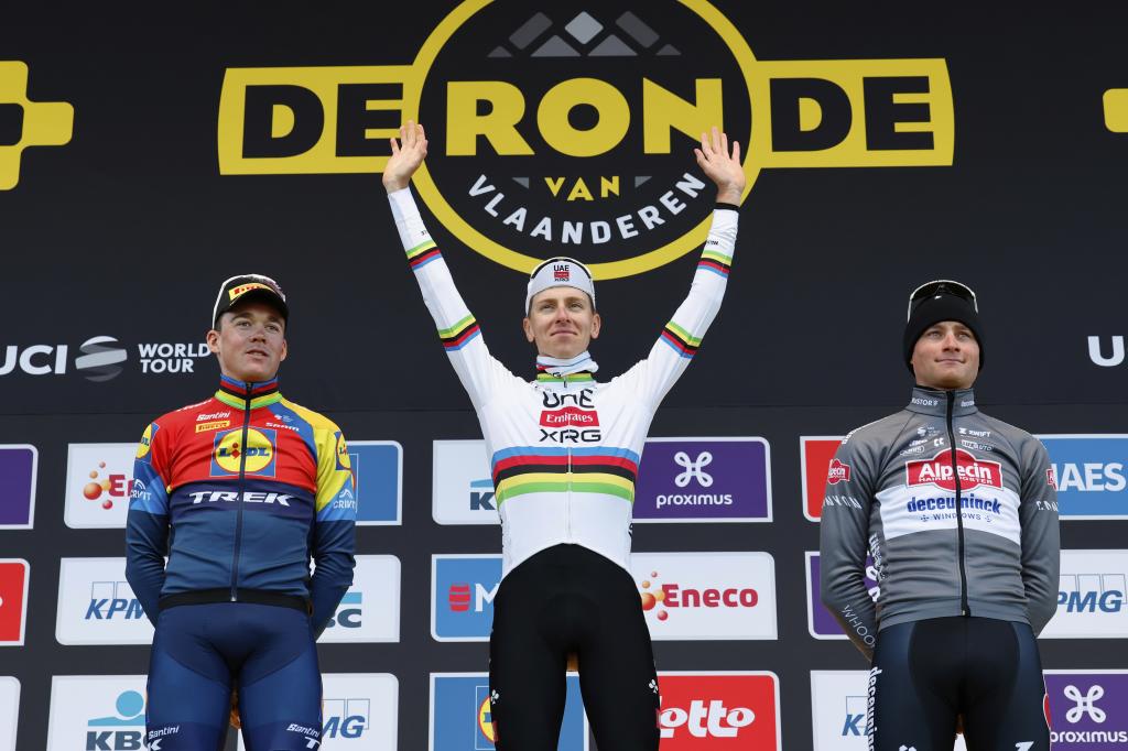 First place, Slovenia's Tadej Pogacar, center, celebrates with second place, Denmark's Mads Pederson, left, and third place, Netherland's Mathieu Van Der Poel.