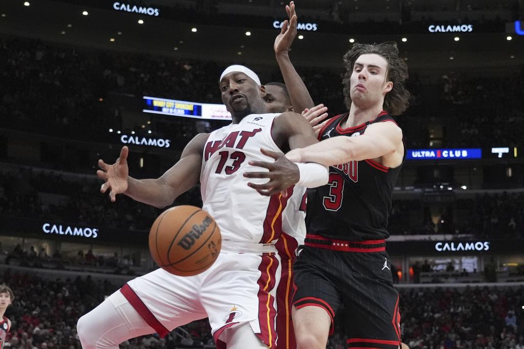 Bam Adebayo and josh Giddey battle for a loose ball.
