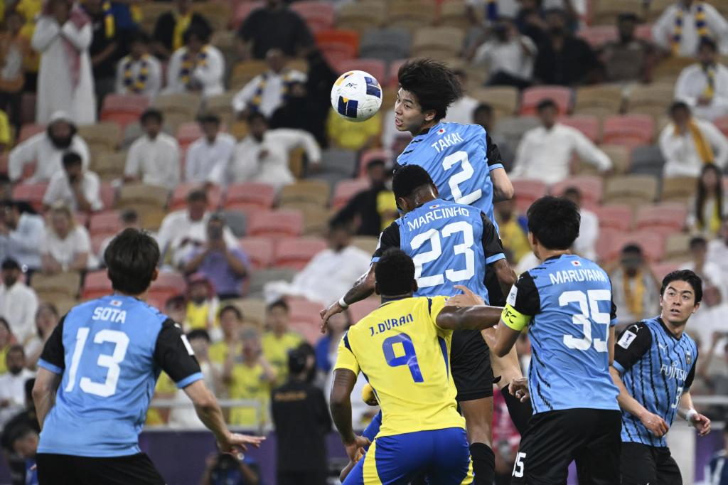 Takai clears the ball after a corner center.