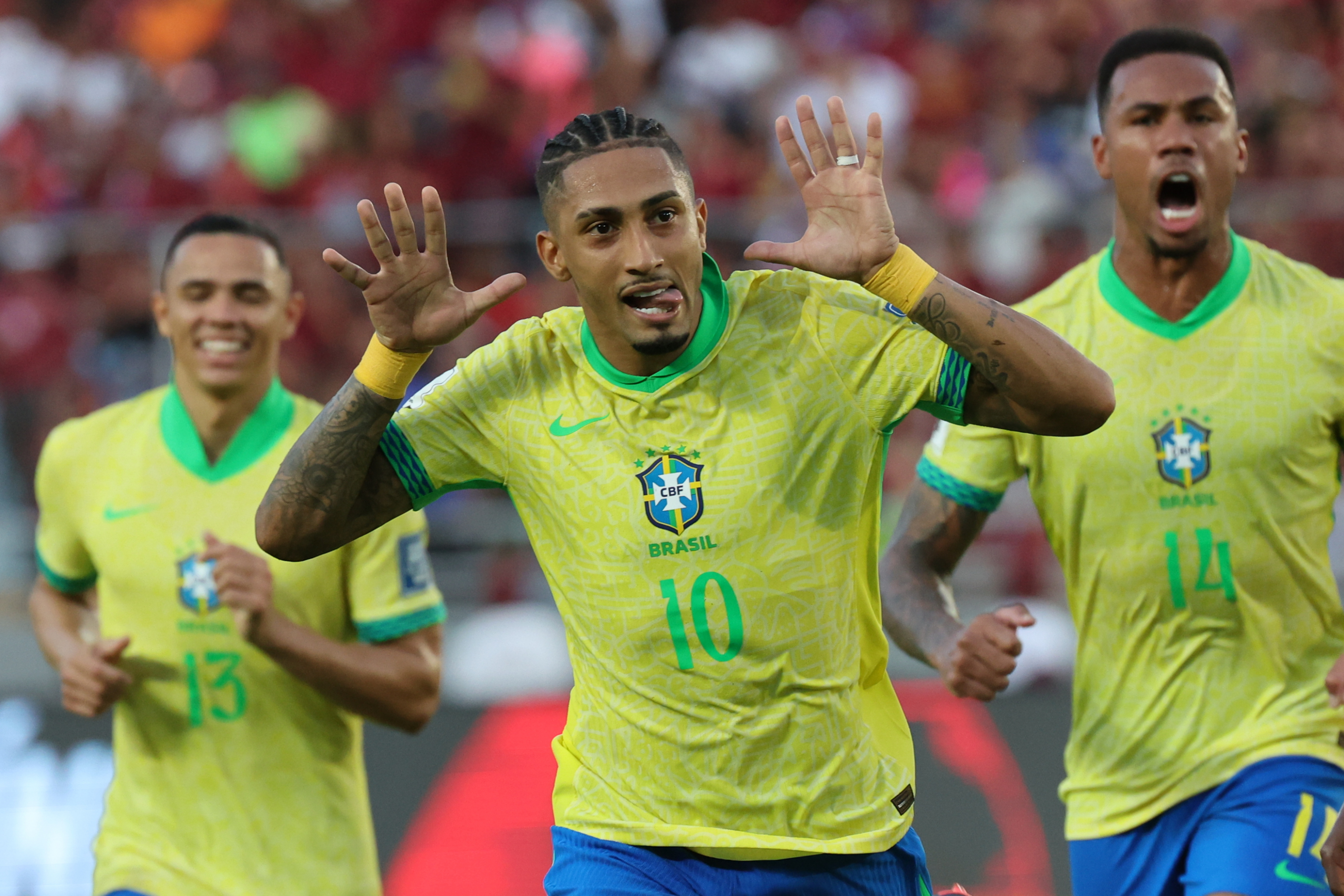 Raphinha celebrates a goal against Venezuela with the Brazilian team.