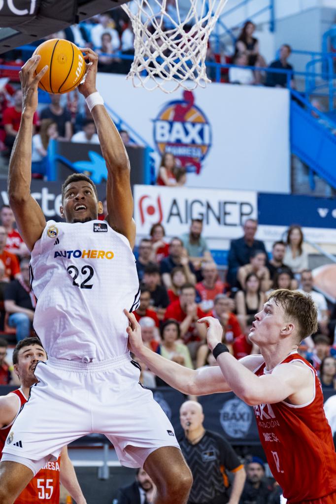 Edy Tavares with the ball against Marcis Steinbergs.