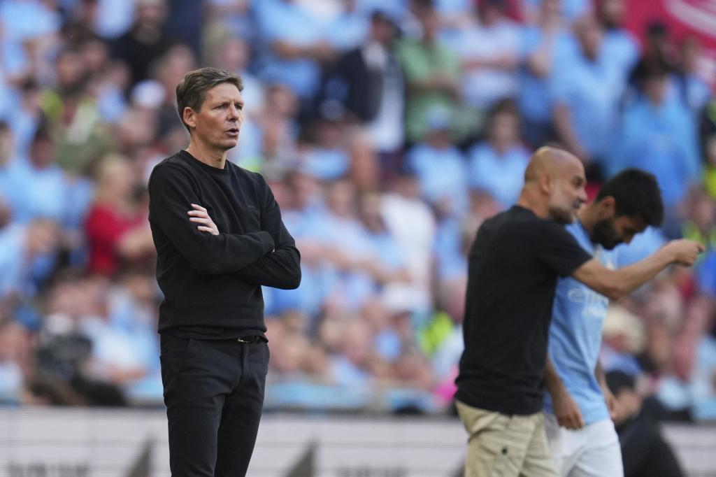 Oliver Glasner, with Pep Guardiola in the background.