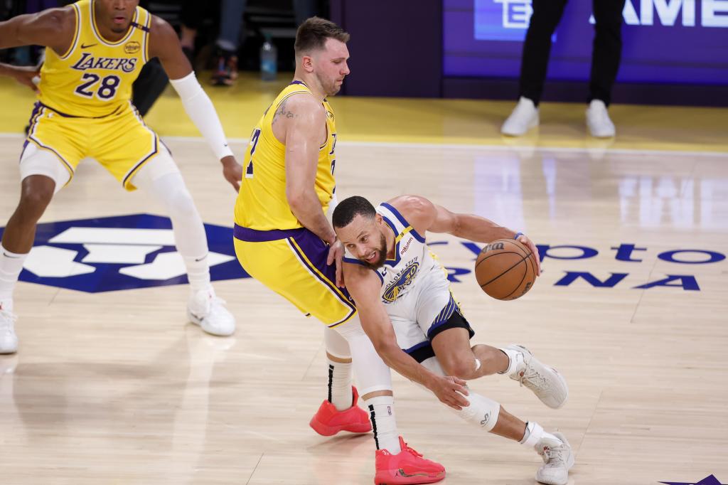 Stephen Curry supera a Luka Doncic durante un Lakers-Warriors.