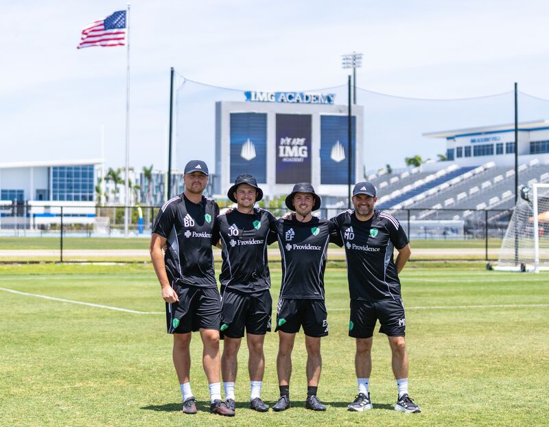 Xavi Bravo in Seattle next to his coaching staff.