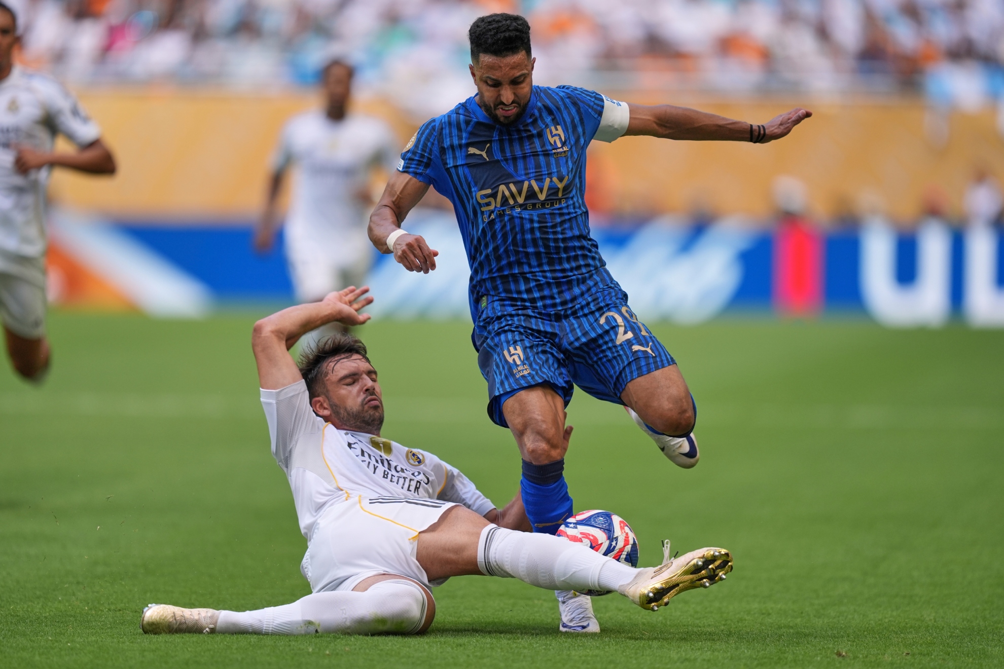 Al Dawsari and Raúl Asencio play a ball at the Club World Cup.