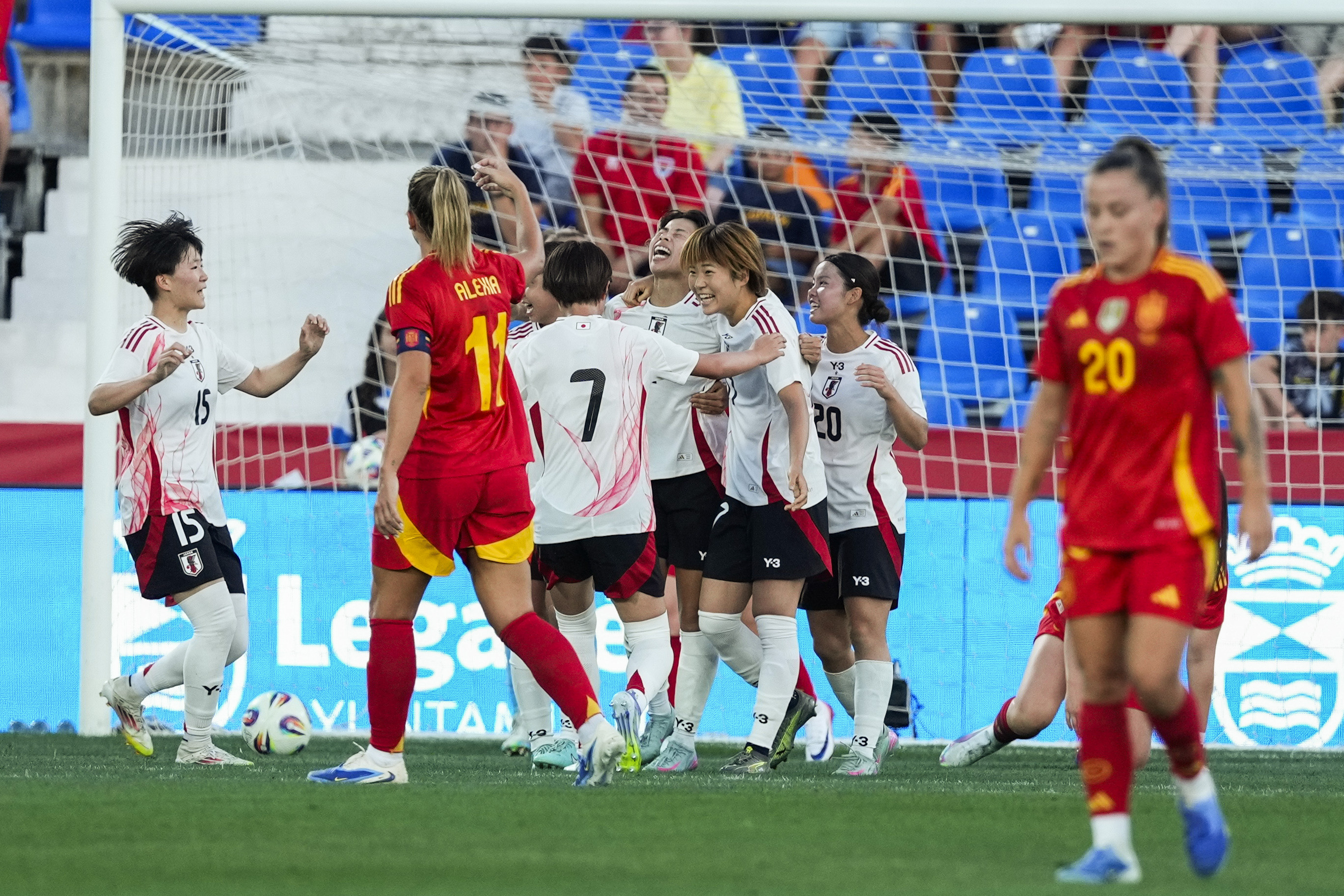 Japan players celebrate Mina Tanaka's goal.