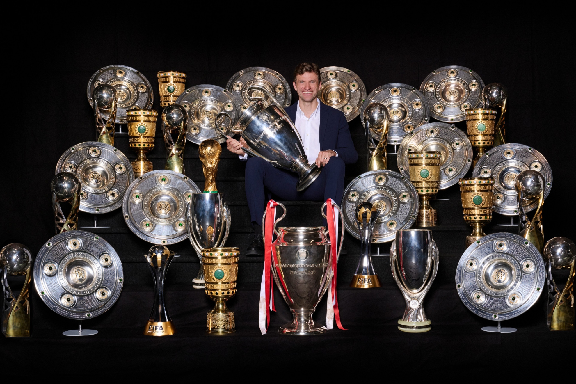 Müller posando con todos los trofeos que ha conseguido en el Bayern