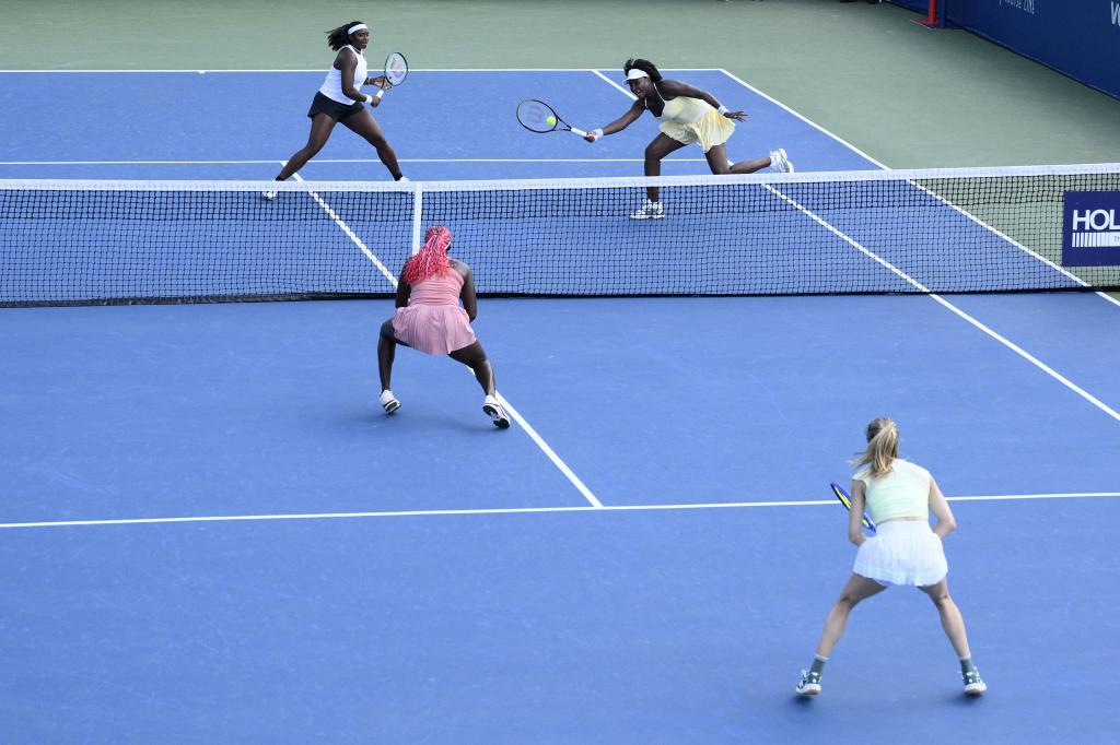 Hailey Baptiste, top left, and Venus Williams top right, compete during a doubles match against Eugenie Bouchard, bottom right, and Clervie Ngounoue, bottom left, at the Citi Open tennis tournament Monday, July 21, 2025, in Washington. (AP Photo/Nick Wass)