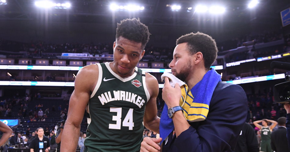 Giannis Antetokounmpo and Stephen Curry speak after an encounter.