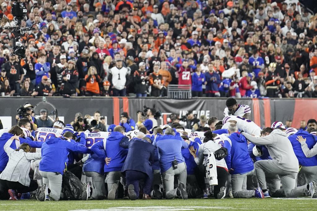 The players of both teams pray for their partner